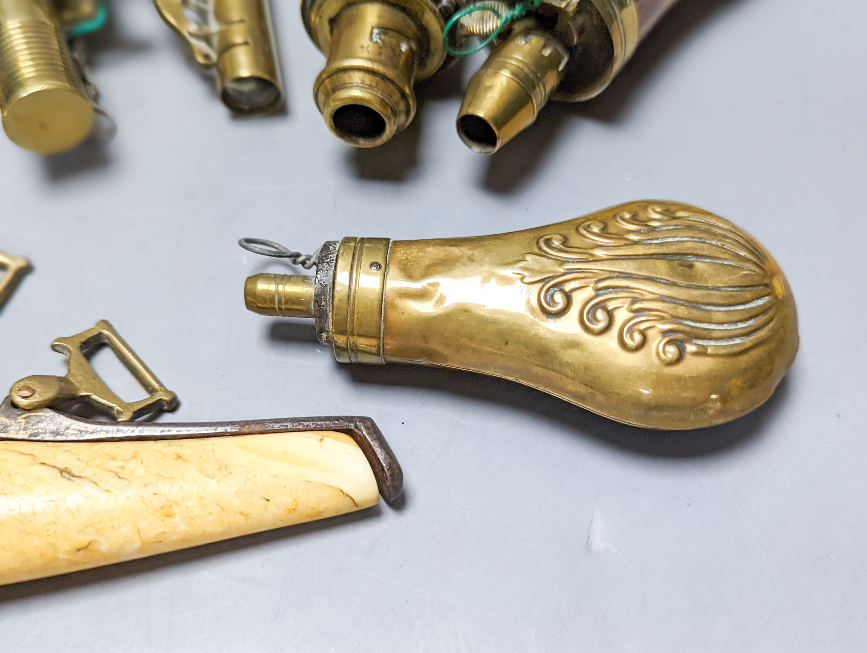 Six powder/shot flasks, 4 copper and brass, 2 leather and brass, together with a carved powder horn (7)